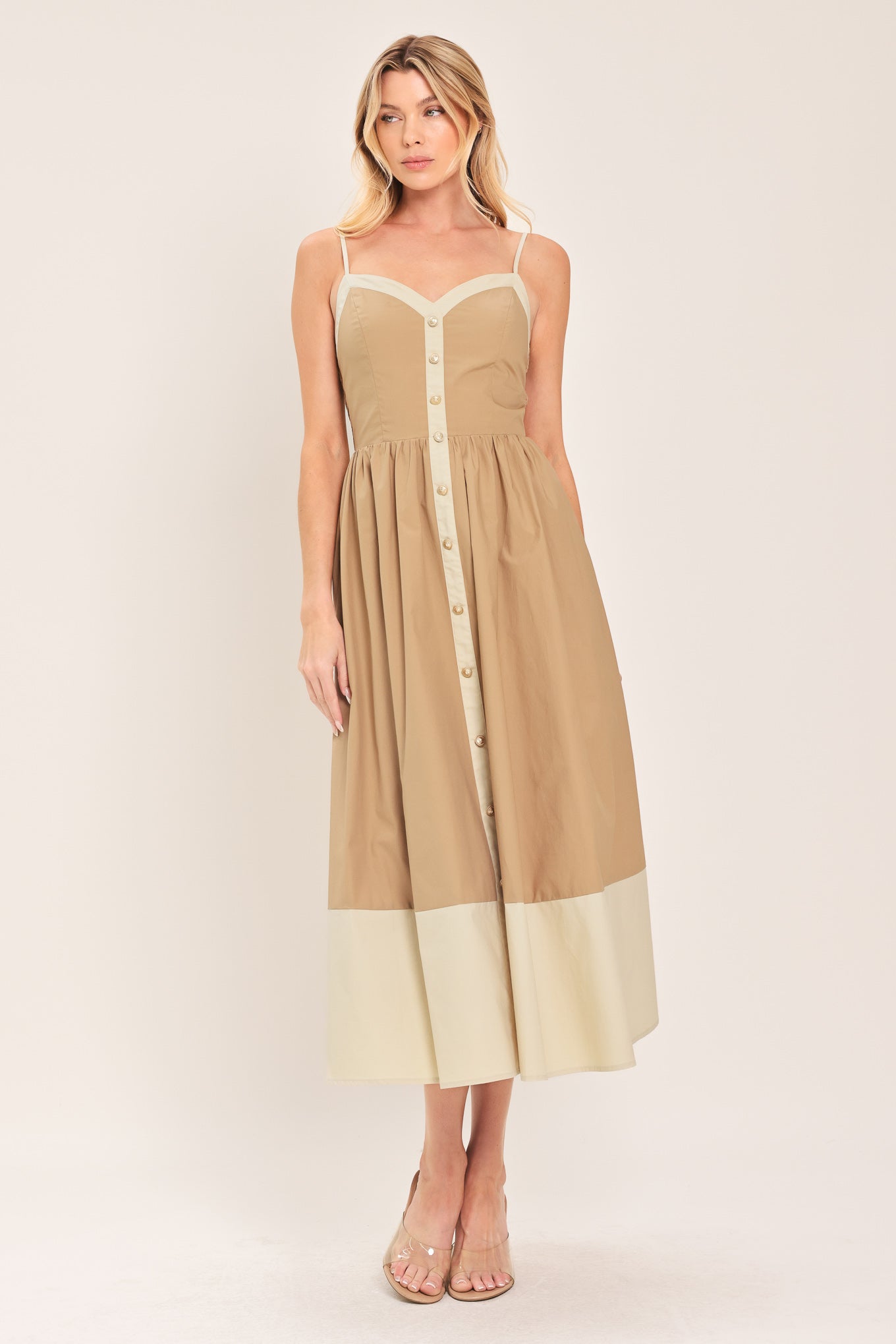 Woman wearing a beige color blocked midi dress featuring sweetheart neckline, straps, button down detail and smocked back bodice | Flying Tomato