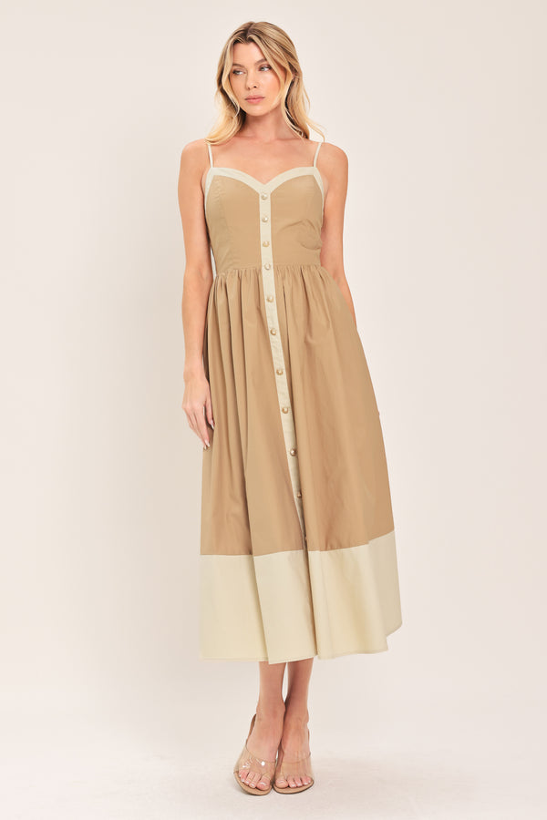 Woman wearing a beige color blocked midi dress featuring sweetheart neckline, straps, button down detail and smocked back bodice | Flying Tomato
