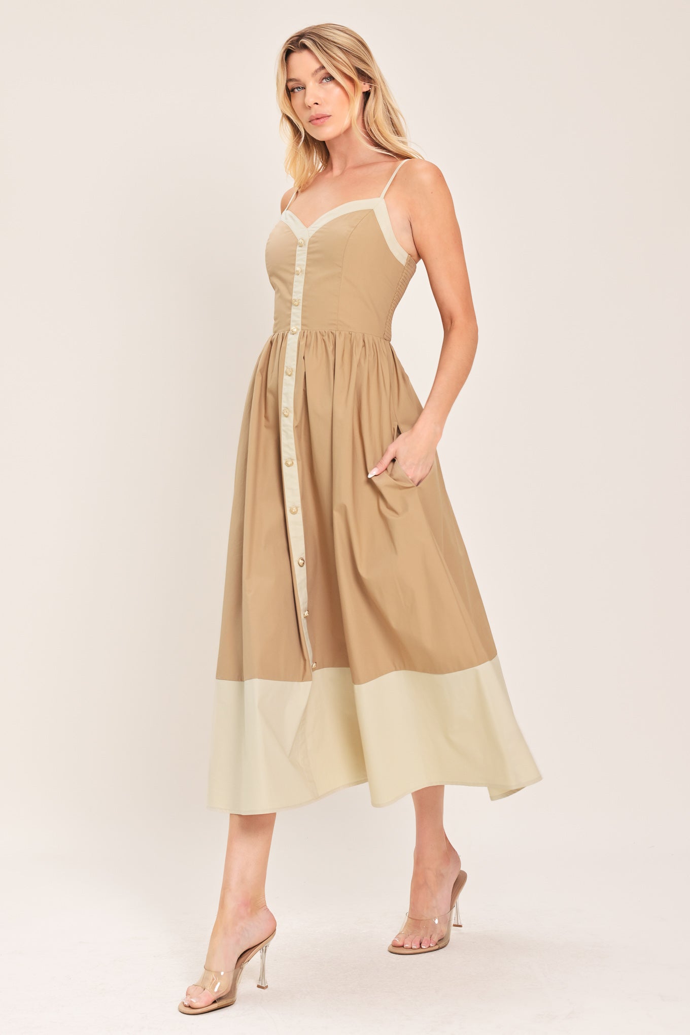 Woman wearing a beige color blocked midi dress featuring sweetheart neckline, straps, button down detail and smocked back bodice | Flying Tomato