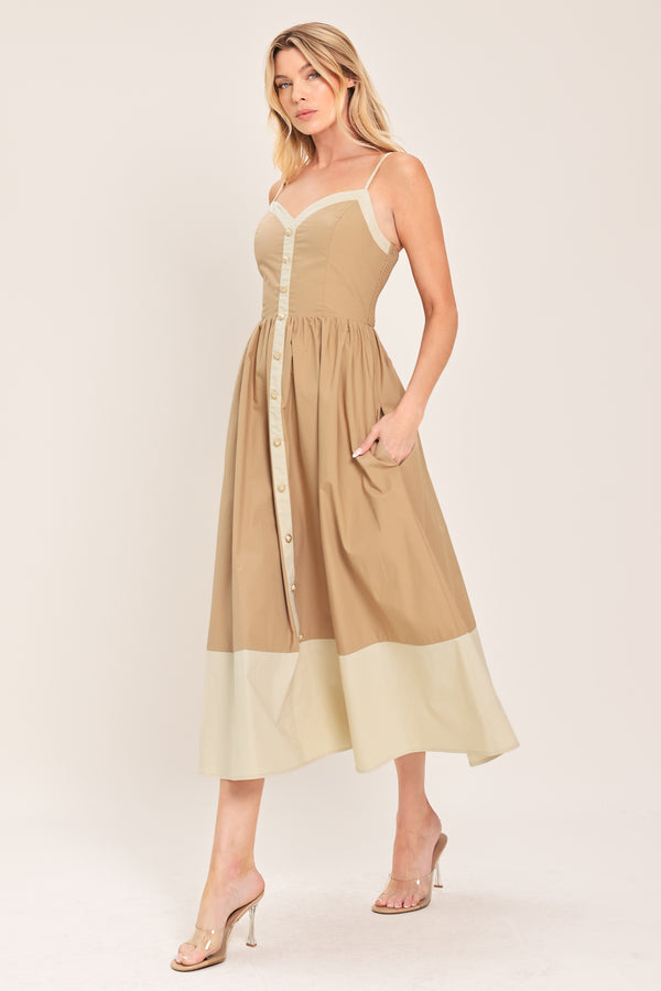 Woman wearing a beige color blocked midi dress featuring sweetheart neckline, straps, button down detail and smocked back bodice | Flying Tomato