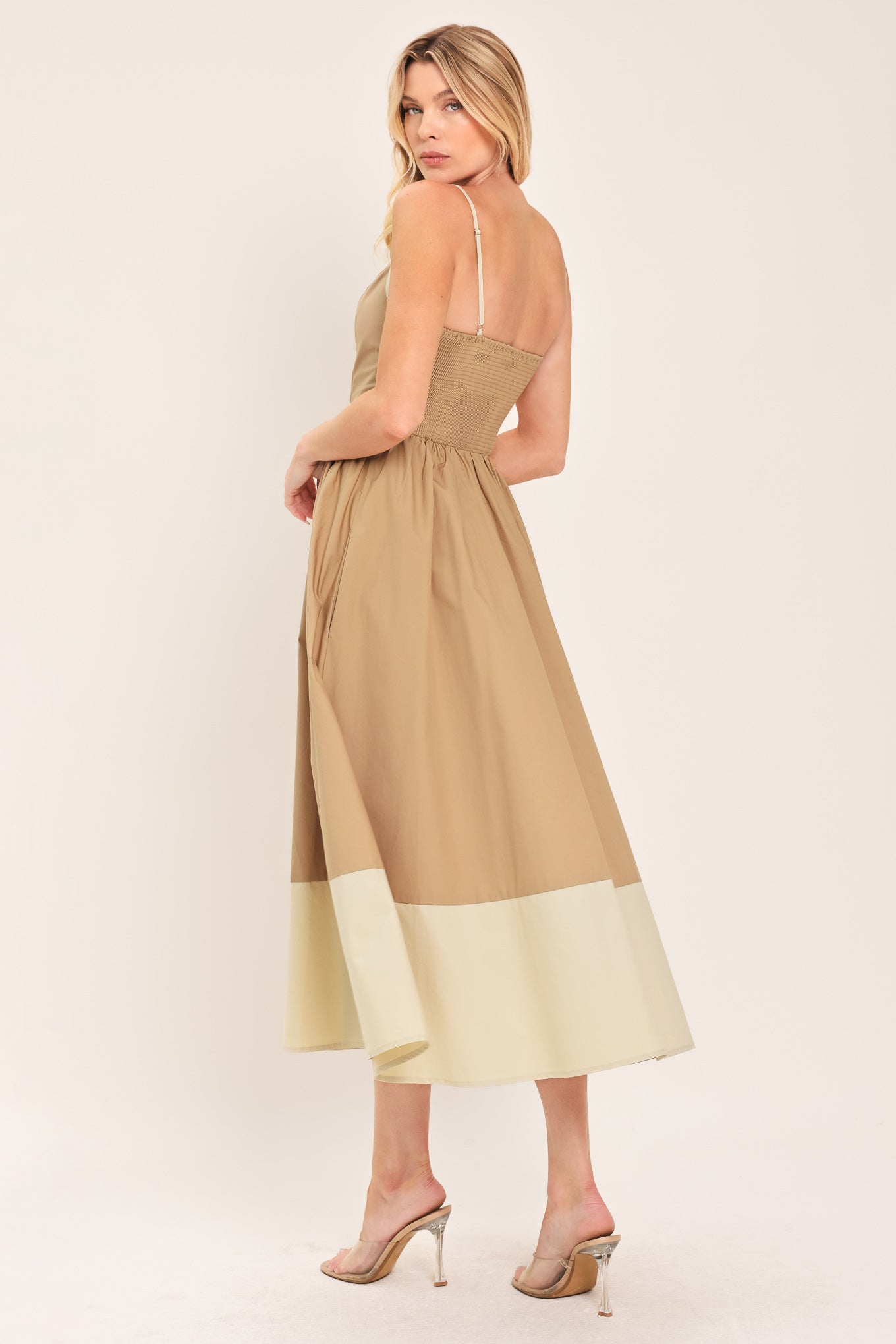 Woman wearing a beige color blocked midi dress featuring sweetheart neckline, straps, button down detail and smocked back bodice | Flying Tomato