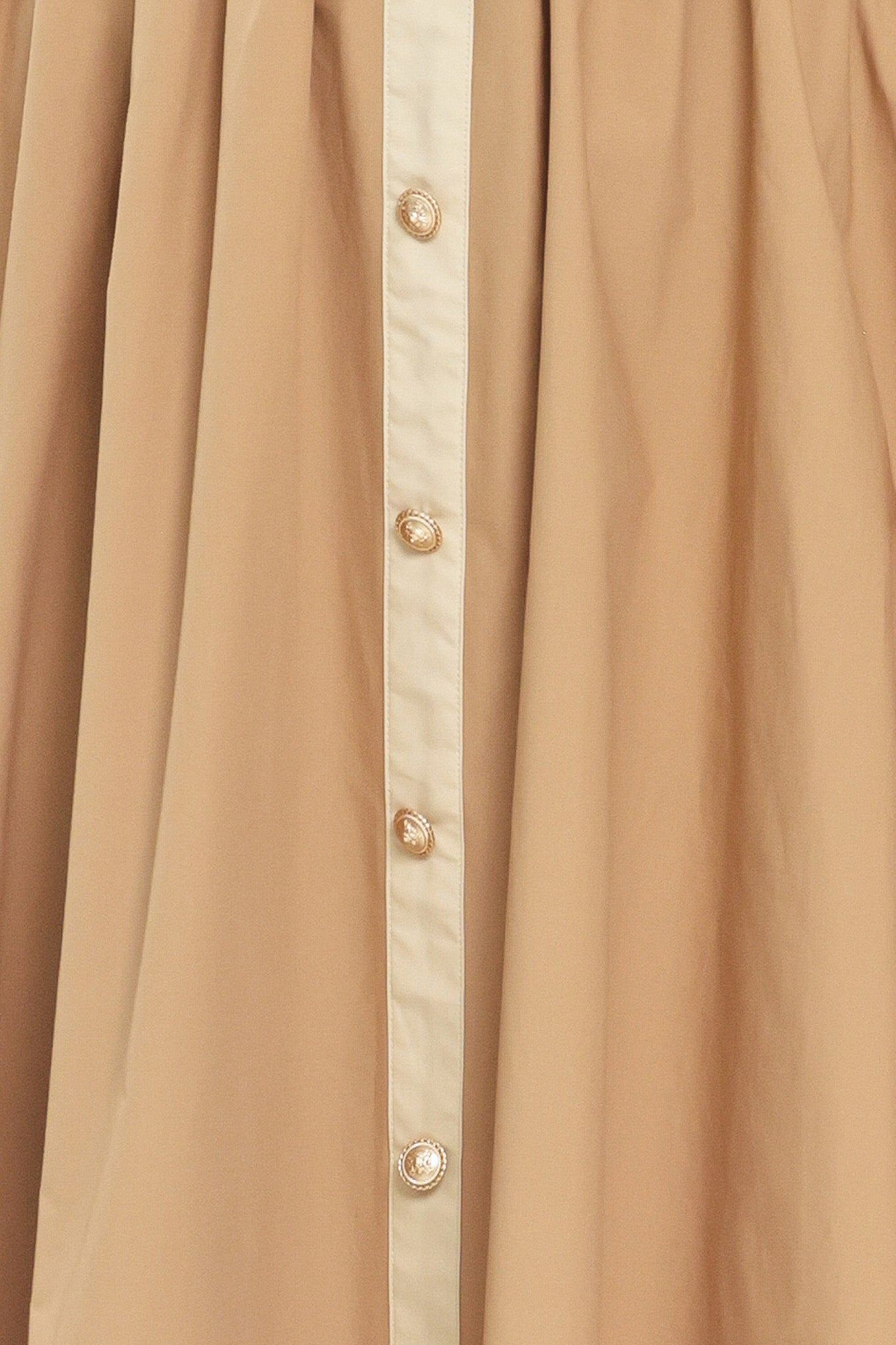 Close up a beige color blocked midi dress featuring sweetheart neckline, straps, button down detail and smocked back bodice | Flying Tomato