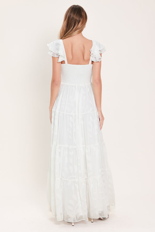 Woman wearing a white maxi dress featuring sweetheart neckline, ruffle sleeve, tier skirt and smocked back bodice  | FREEMARKET