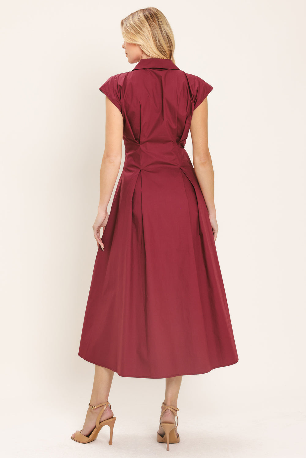 Woman wearing a burgundy midi dress featuring V neckline with collared finish, short sleeve, lace up corset waist and front button down | Flying Tomato