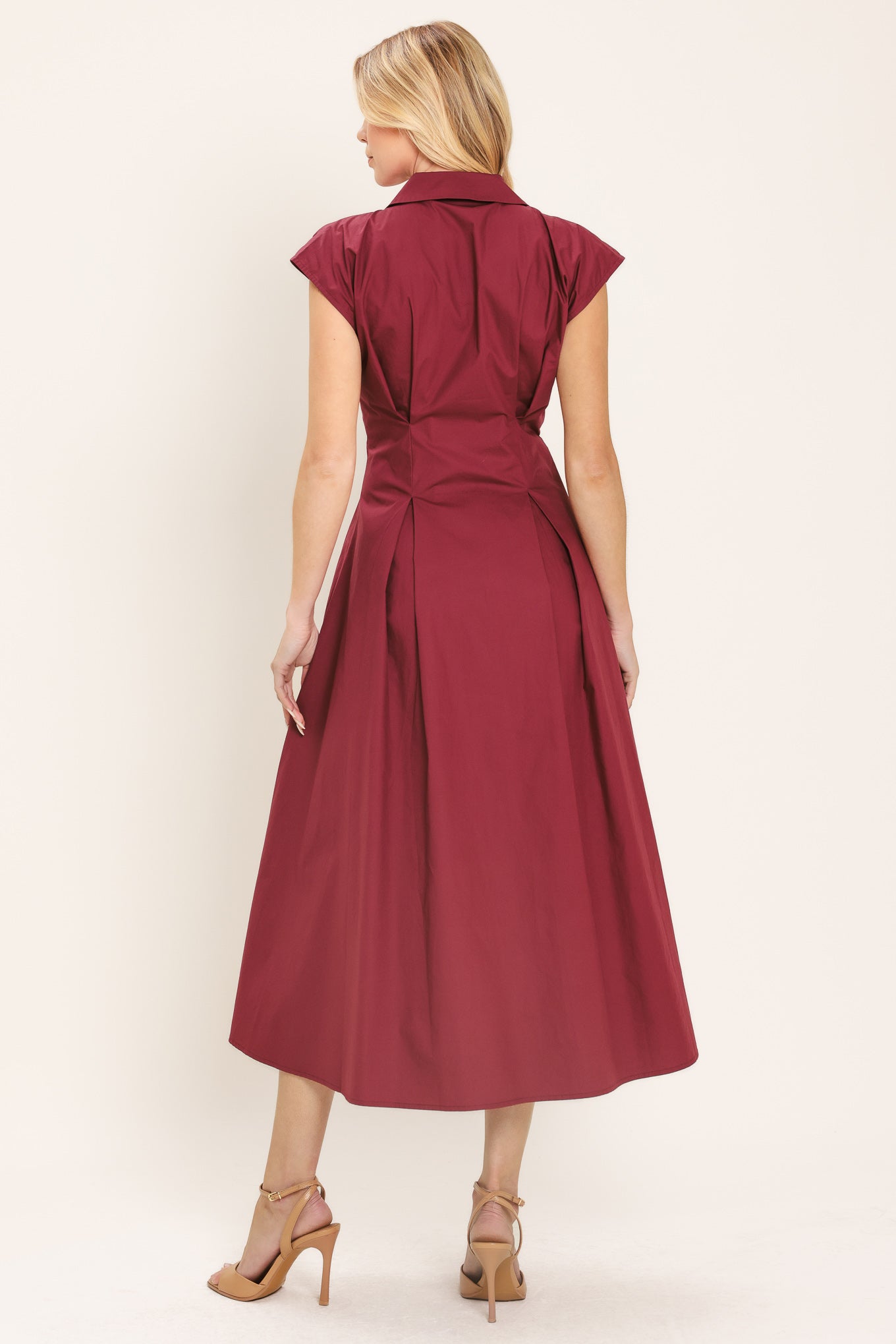 Woman wearing a burgundy midi dress featuring V neckline with collared finish, short sleeve, lace up corset waist and front button down | Flying Tomato