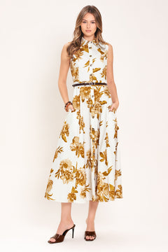 Woman wearing a sleeveless ivory midi dress with brown floral print featuring collar, front button down, contrasting belt and circle skirt | Flying Tomato