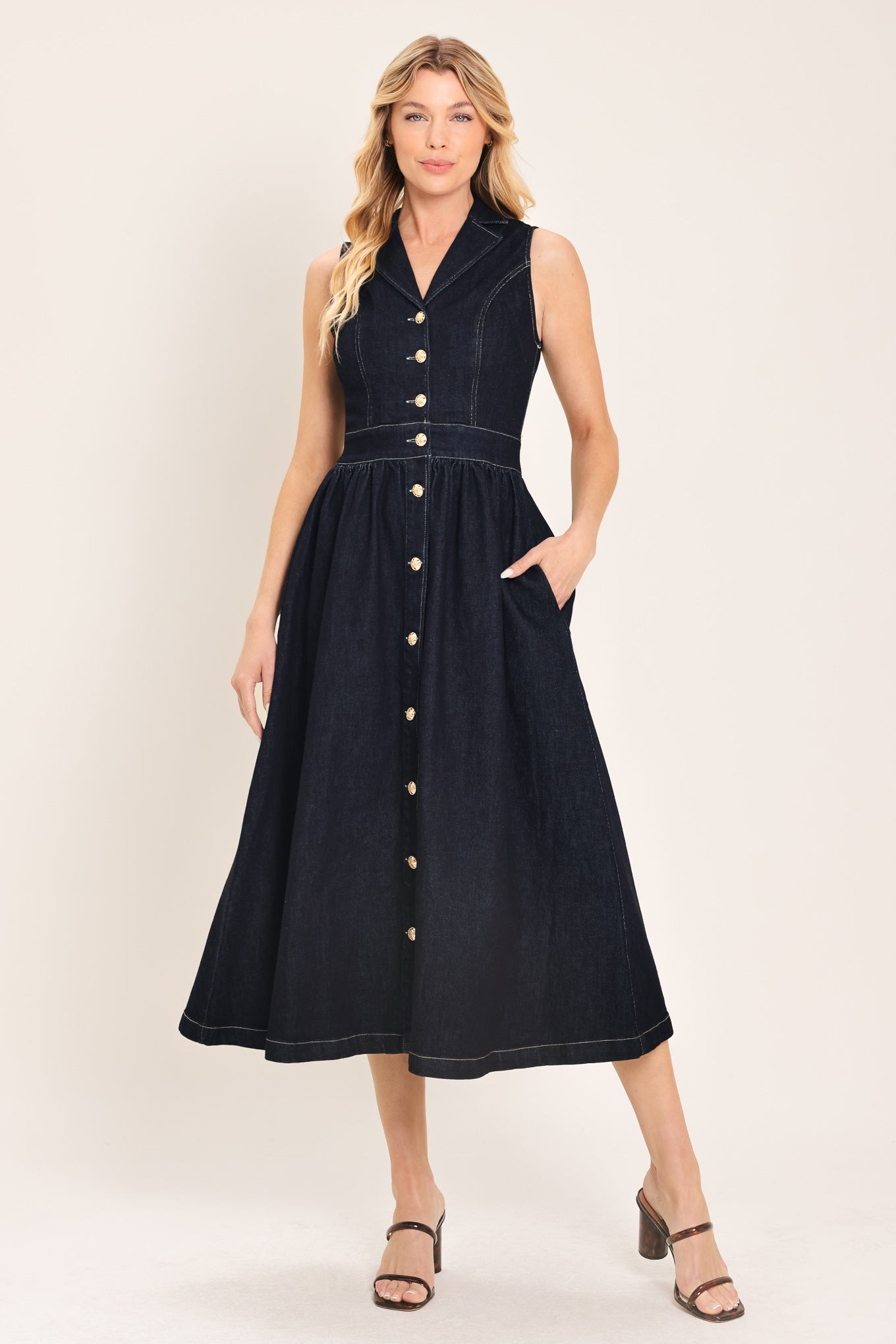 Woman wearing a black sleeveless dark denim midi dress featuring collar, sleeveless, button down and full skirt | Flying Tomato