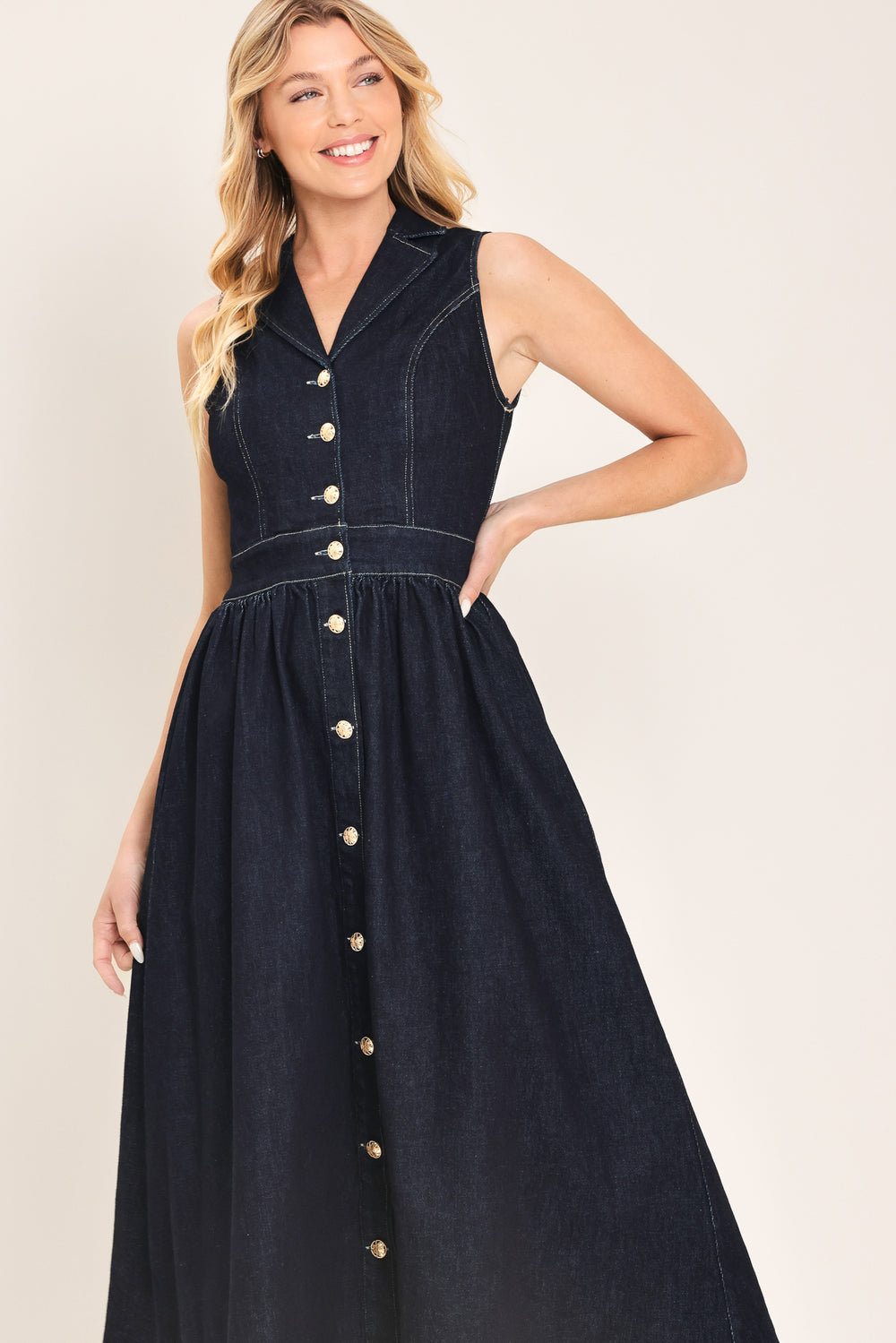 Woman wearing a black sleeveless dark denim midi dress featuring collar, sleeveless, button down and full skirt | Flying Tomato