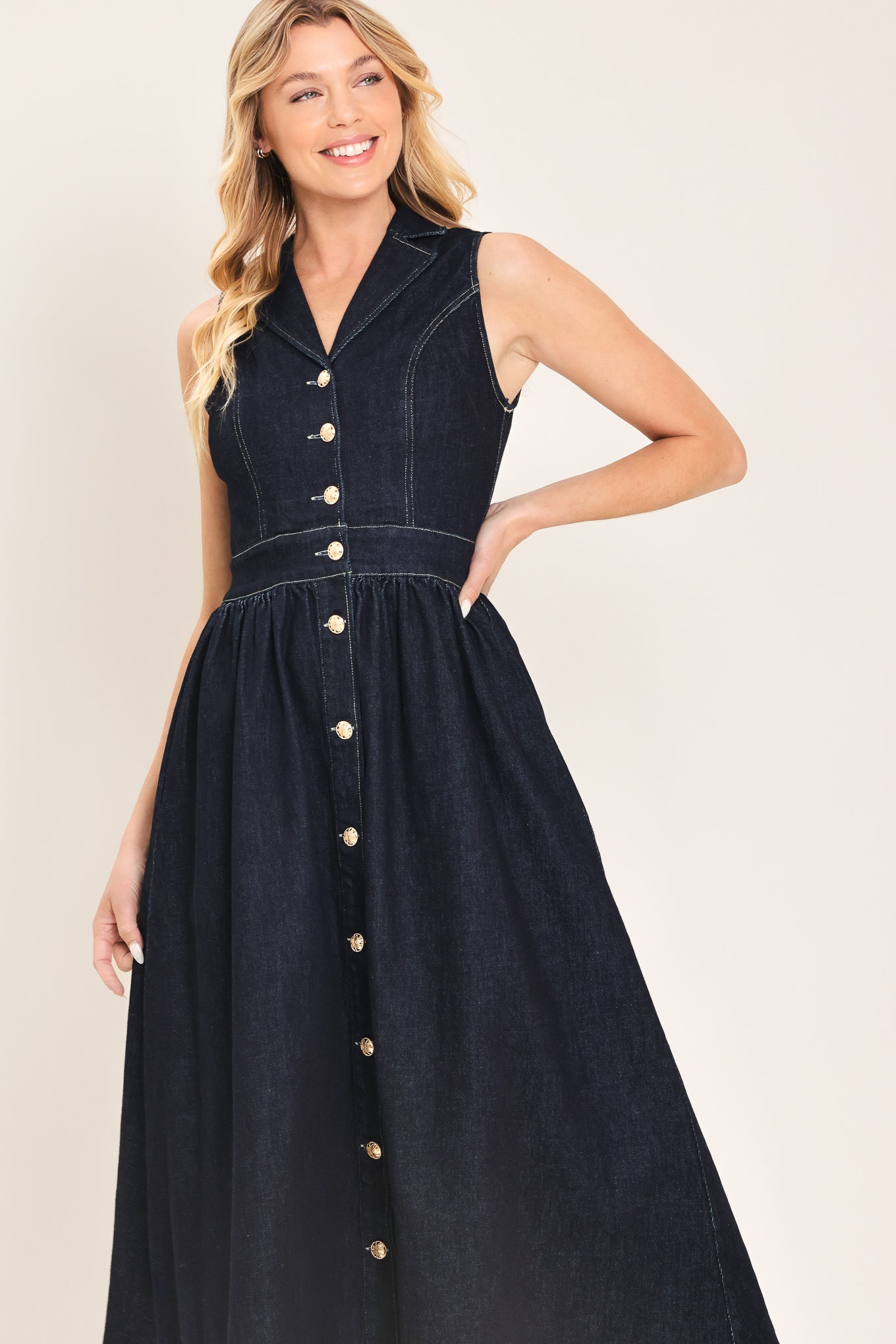 Woman wearing a black sleeveless dark denim midi dress featuring collar, sleeveless, button down and full skirt | Flying Tomato