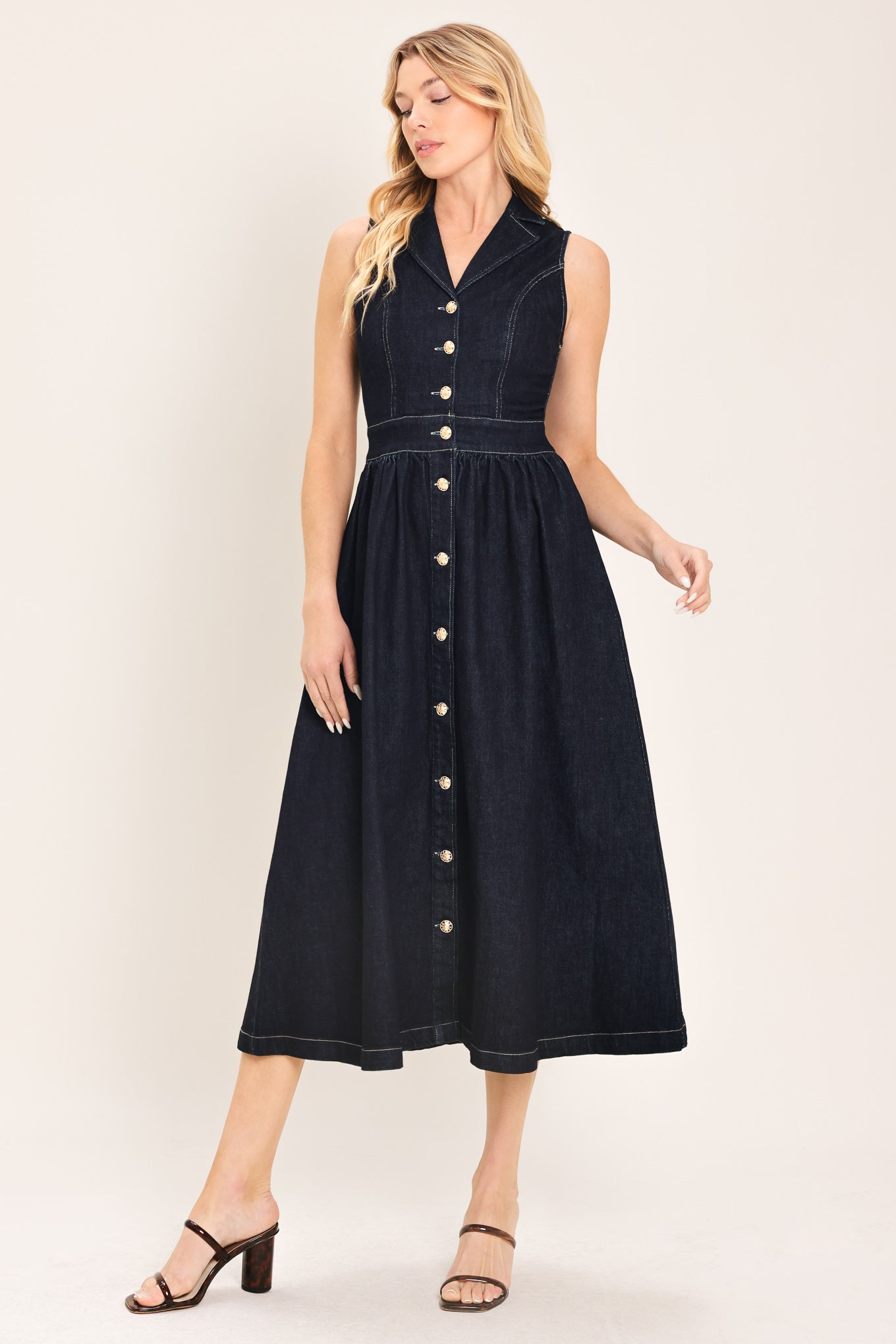 Woman wearing a black sleeveless dark denim midi dress featuring collar, sleeveless, button down and full skirt | Flying Tomato