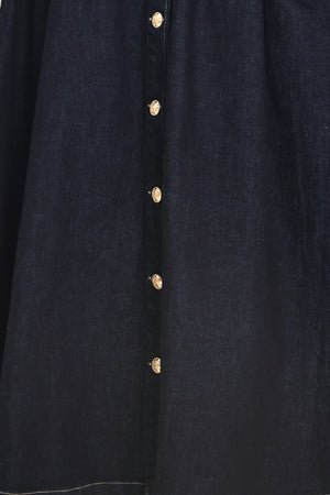 Woman wearing a black sleeveless dark denim midi dress featuring collar, sleeveless, button down and full skirt | Flying Tomato