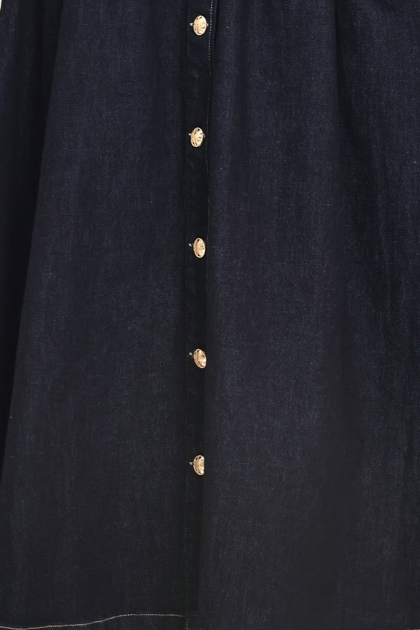 Woman wearing a black sleeveless dark denim midi dress featuring collar, sleeveless, button down and full skirt | Flying Tomato