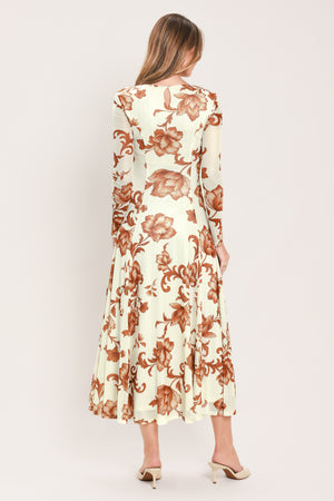 A woman wearing a long-sleeve midi dress with a cream base and a brown baroque-style floral pattern | Flying Tomato