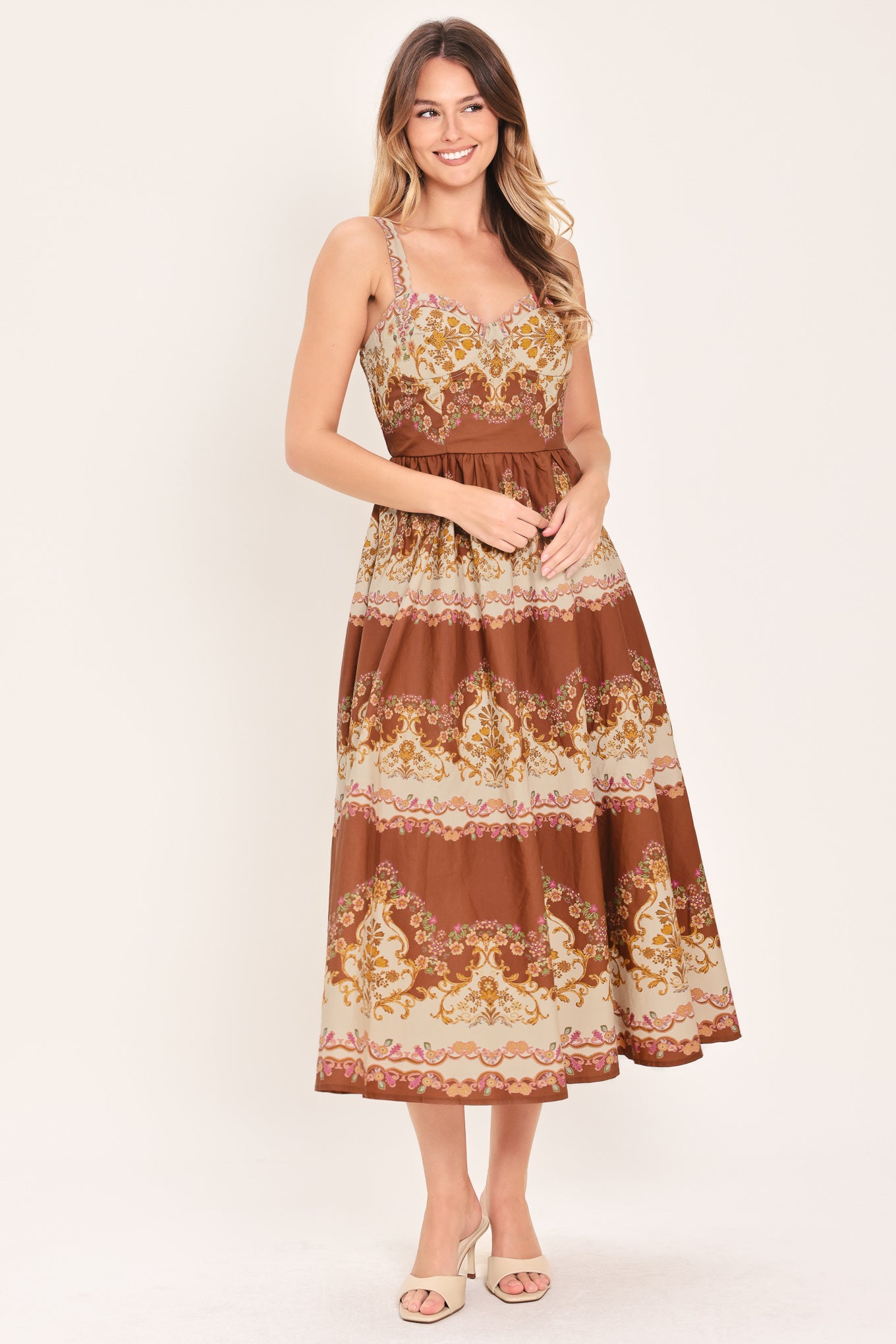 Woman wearing a brown floral midi dress featuring bustier top, straps, full skirt and smocked back bodice | Flying Tomato