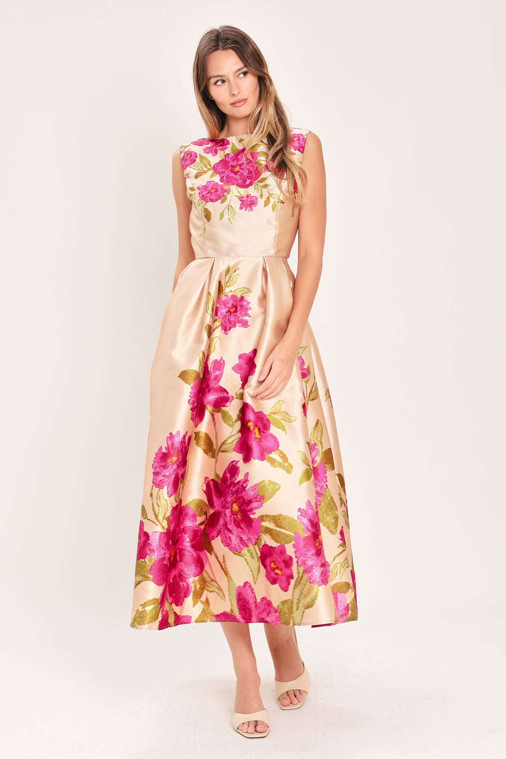 Woman wearing a sleeveless pink floral midi dress featuring wide neckline, full skirt, back cut out and zipper closure | Flying Tomato