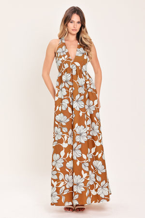 Woman wearing a camel and white with black lineart floral maxi dress maxi dress featuring halter neckline with back neck tie, bare back and smocked bodice | Flying Tomato