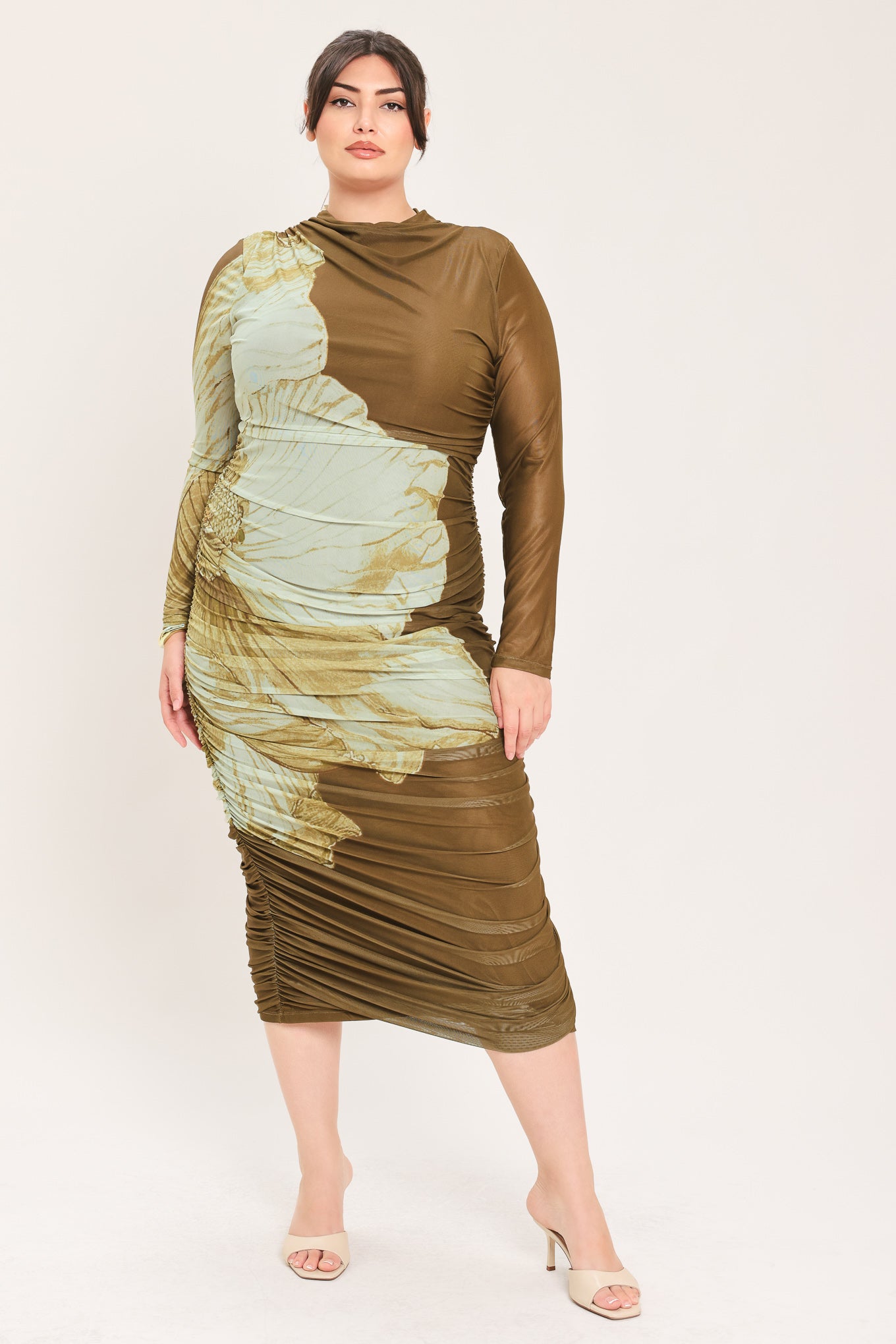 A woman models a long-sleeve midi dress with a brown base and a large beige floral print | Flying Tomato Curve