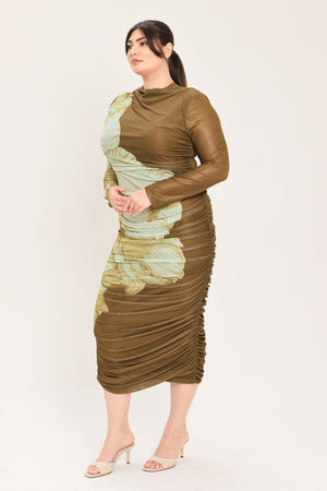 A woman models a long-sleeve midi dress with a brown base and a large beige floral print | Flying Tomato Curve
