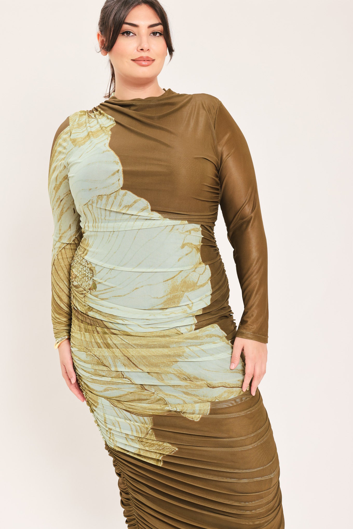 A woman models a long-sleeve midi dress with a brown base and a large beige floral print | Flying Tomato Curve