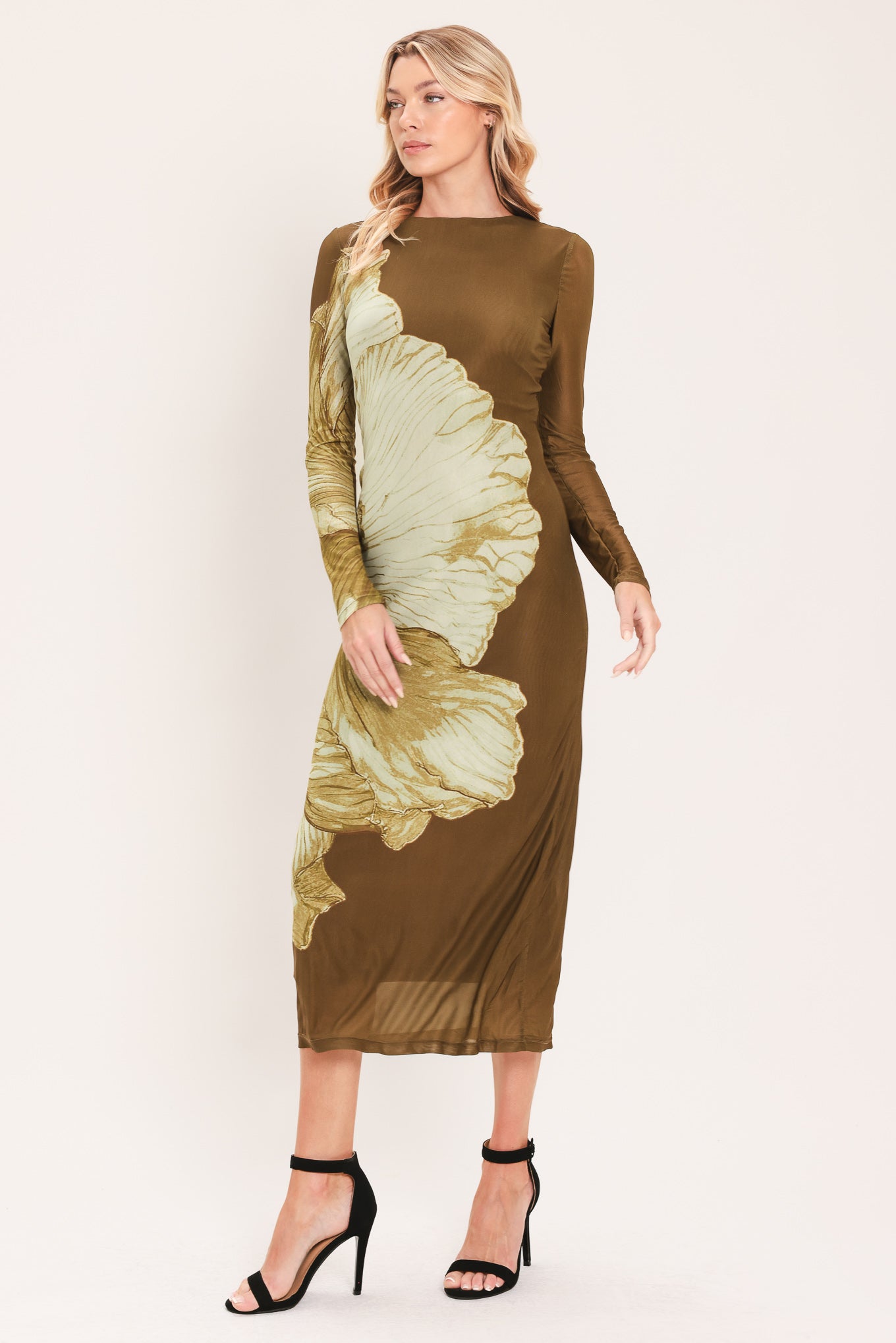 A woman models a long-sleeve midi dress with a brown base and a large beige floral print | Flying Tomato