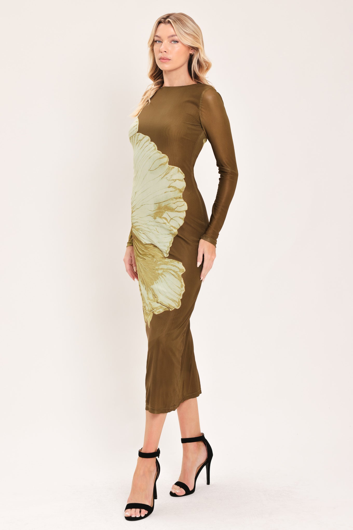 A woman models a long-sleeve midi dress with a brown base and a large beige floral print | Flying Tomato