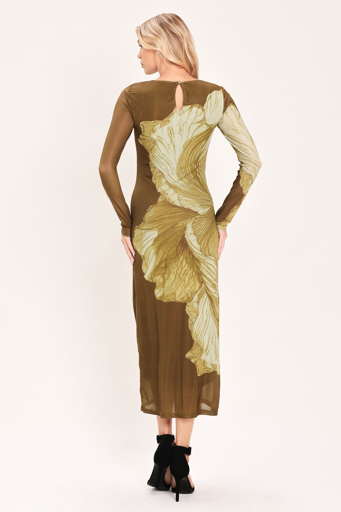 A woman models a long-sleeve midi dress with a brown base and a large beige floral print | Flying Tomato