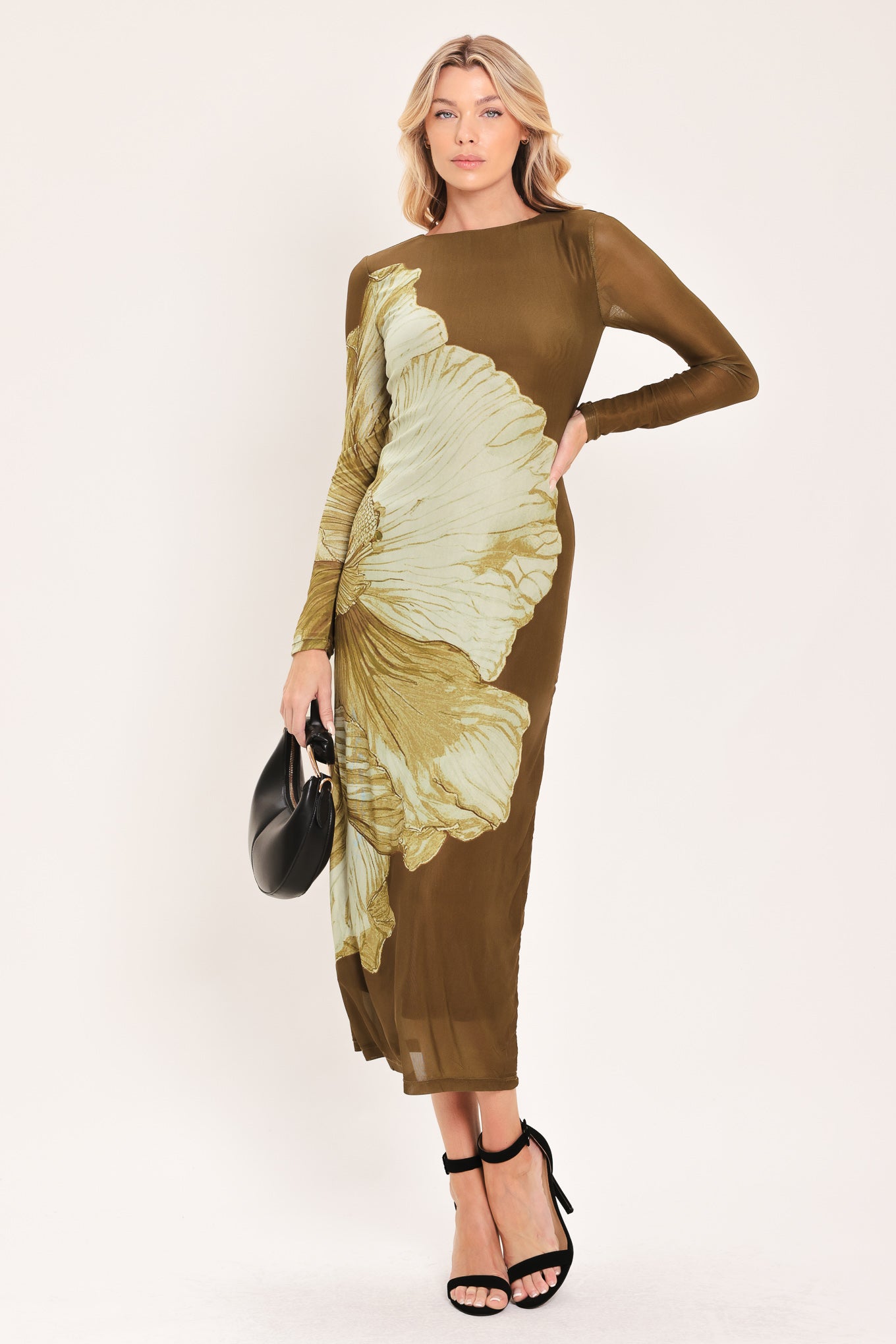 A woman models a long-sleeve midi dress with a brown base and a large beige floral print | Flying Tomato