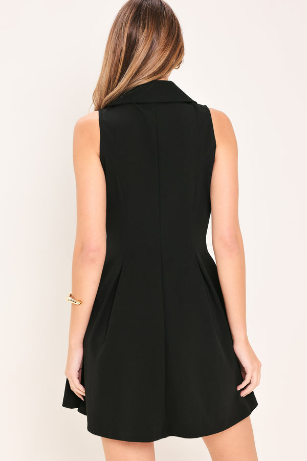 Woman wearing a black sleeveless  woven mini dress featuring peter pan collar, button down and circle skirt | Flying Tomato