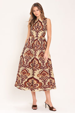 Woman wearing a taupe patterned  midi dress featuring round neckline, sleeveless, full skirt and back zipper closure | Flying Tomato