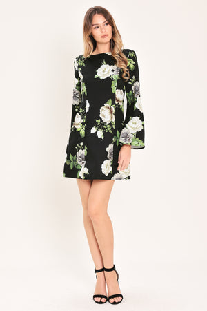 Woman wearing a black with white floral pattern mini dress with wide neckline, long bell sleeve and back zipper closure | Flying Tomato