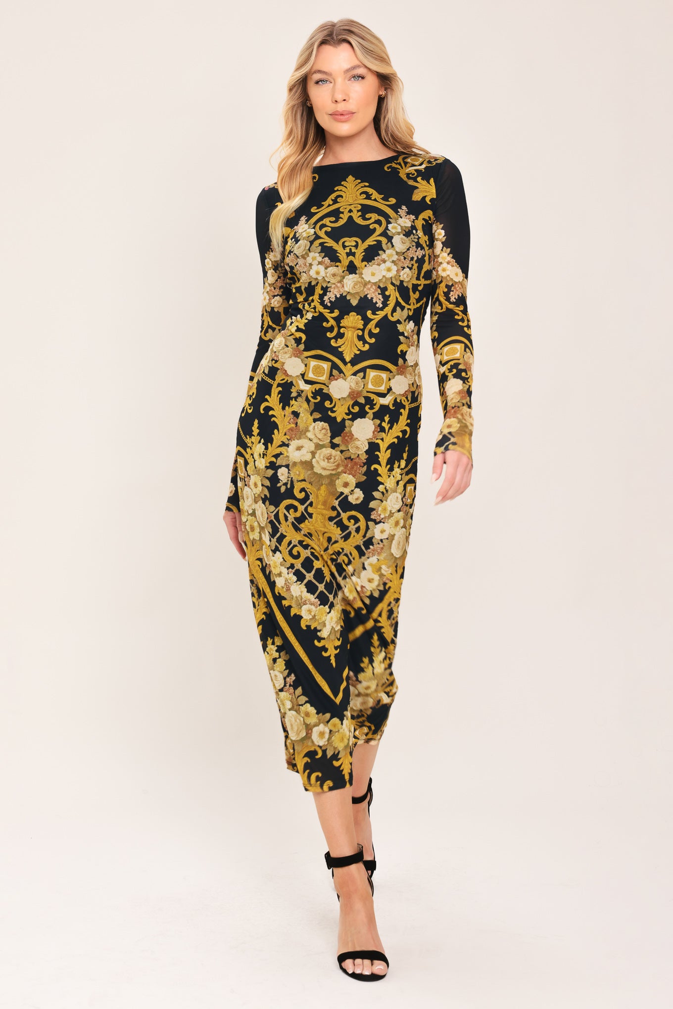 Woman wearing a black and gold baroque printed power mesh midi dress with long sleeve and back neck button | Flying Tomato