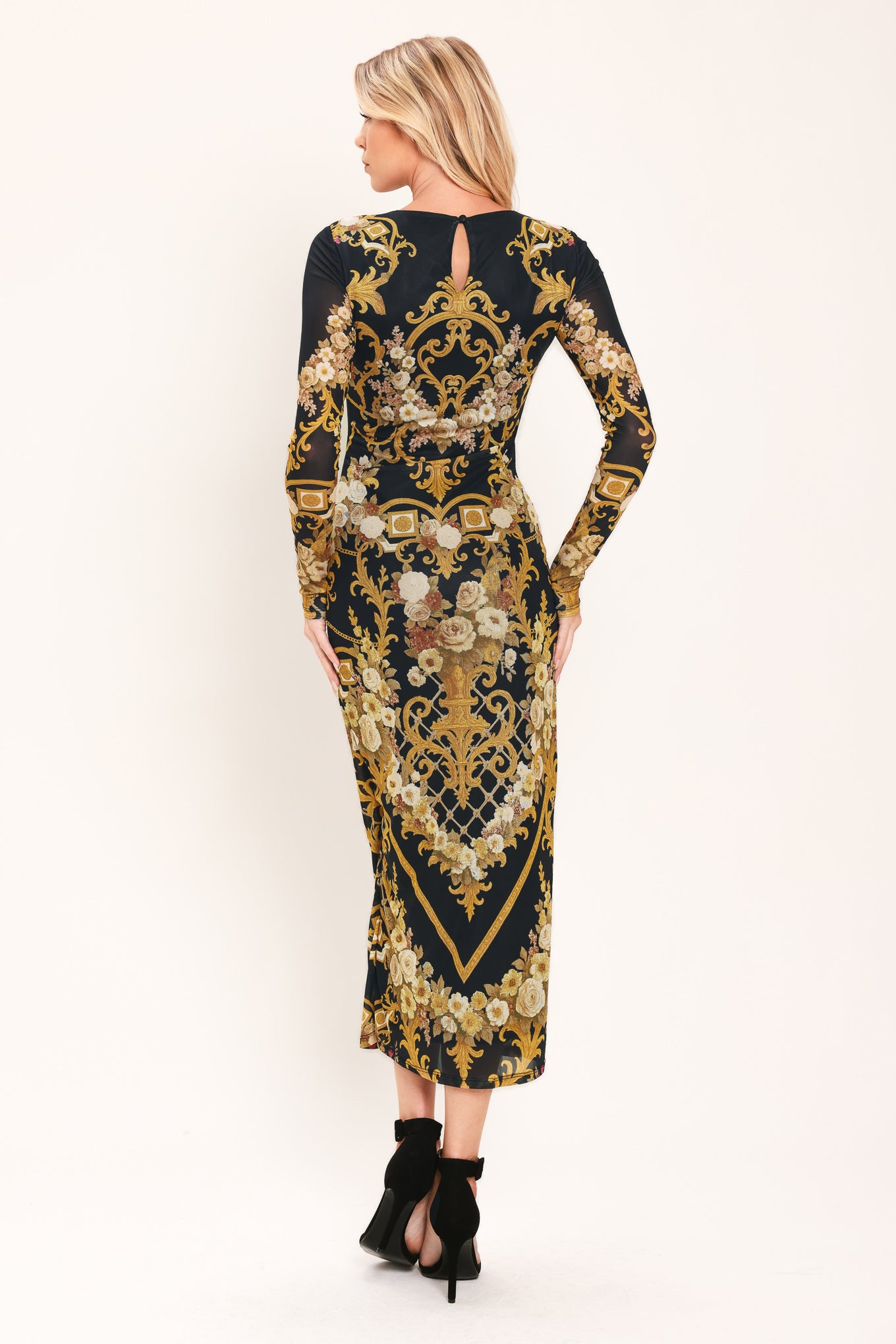Woman wearing a black and gold baroque printed power mesh midi dress with long sleeve and back neck button | Flying Tomato
