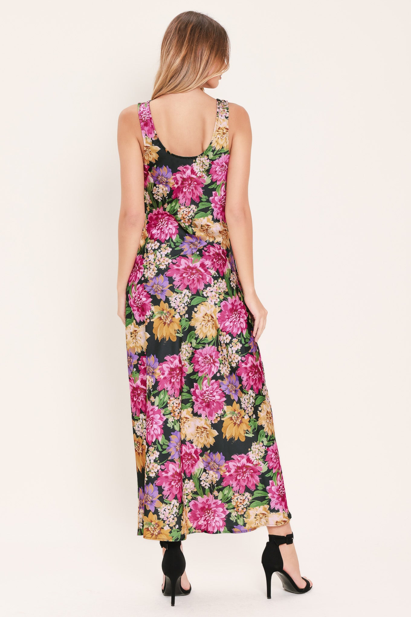 Woman wearing a multicolor pink, yellow, and green floral midi dress with cowl neck and side zipper closure | Flying Tomato