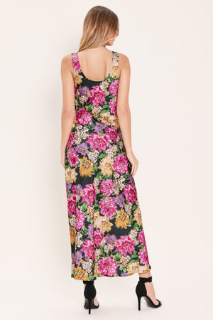 Woman wearing a multicolor pink, yellow, and green floral midi dress with cowl neck and side zipper closure | Flying Tomato