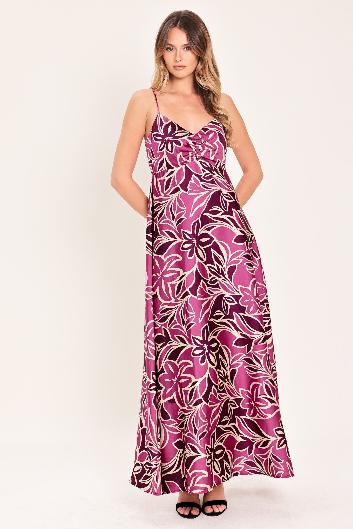 Woman wearing a pink and berry colored tropical floral maxi dress | Flying Tomato