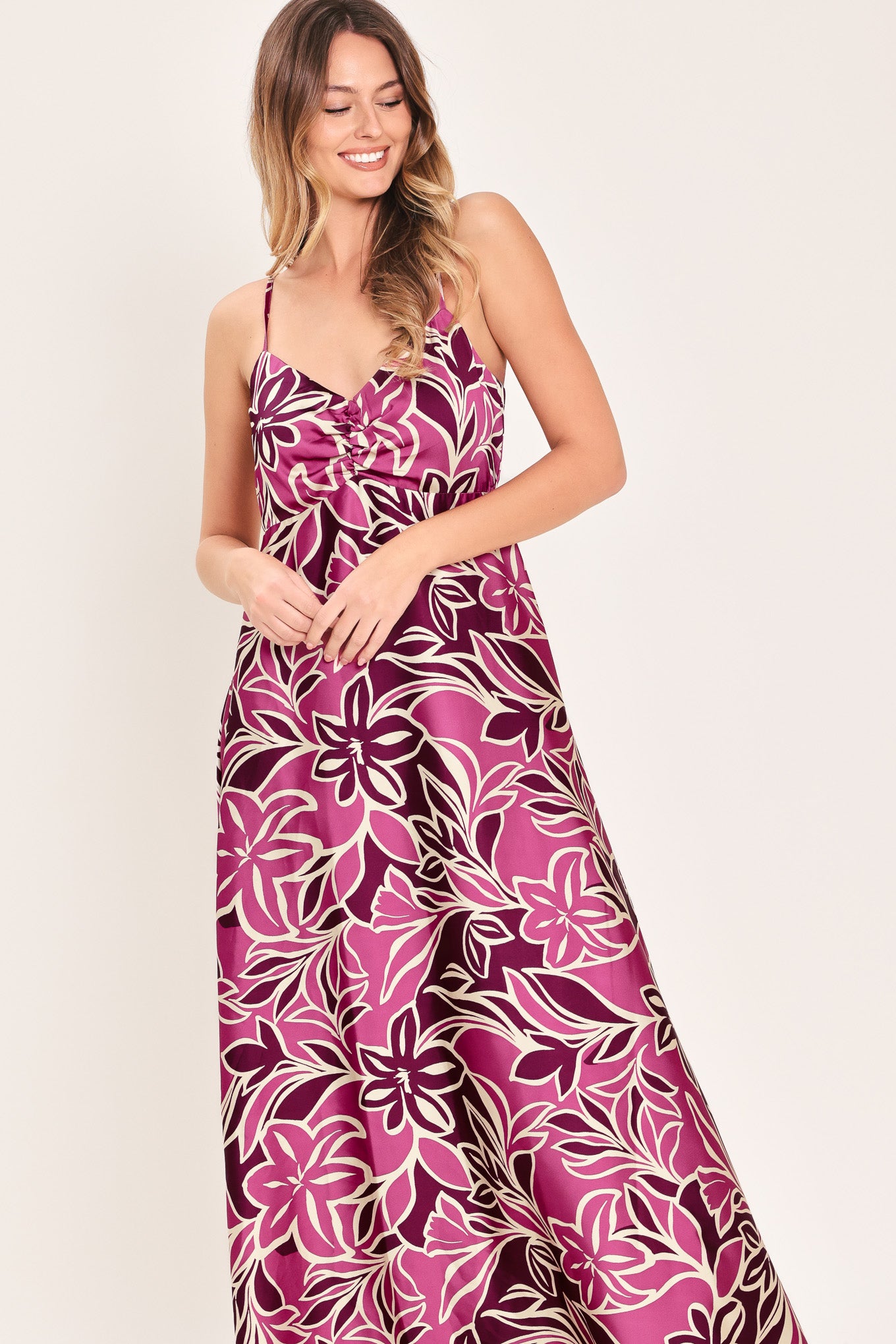 Woman wearing a pink and berry colored tropical floral maxi dress | Flying Tomato
