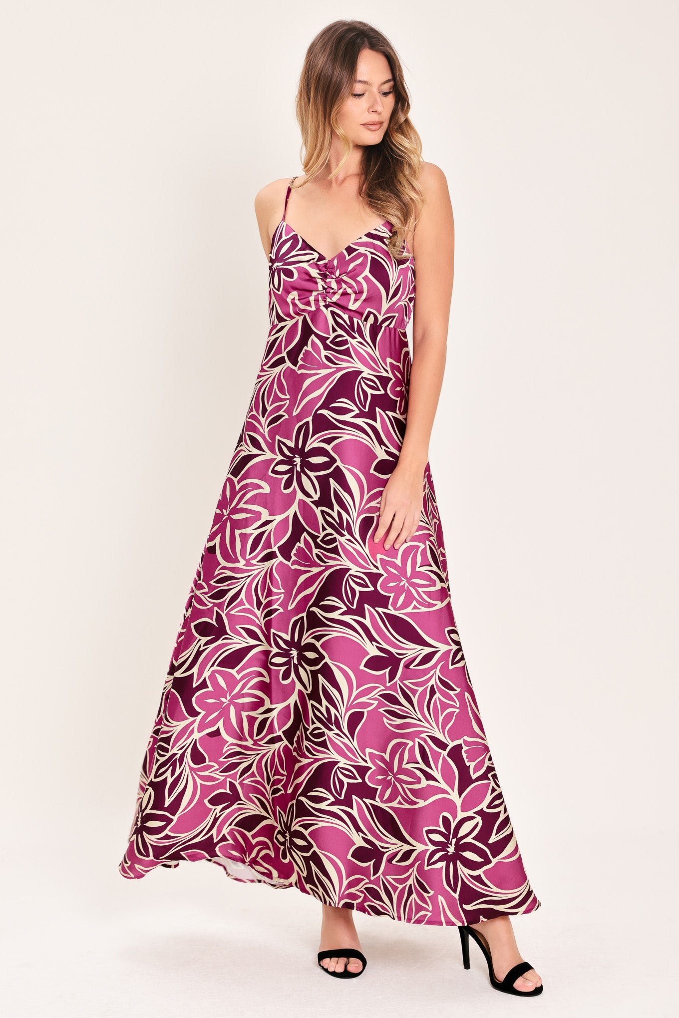 Woman wearing a pink and berry colored tropical floral maxi dress | Flying Tomato