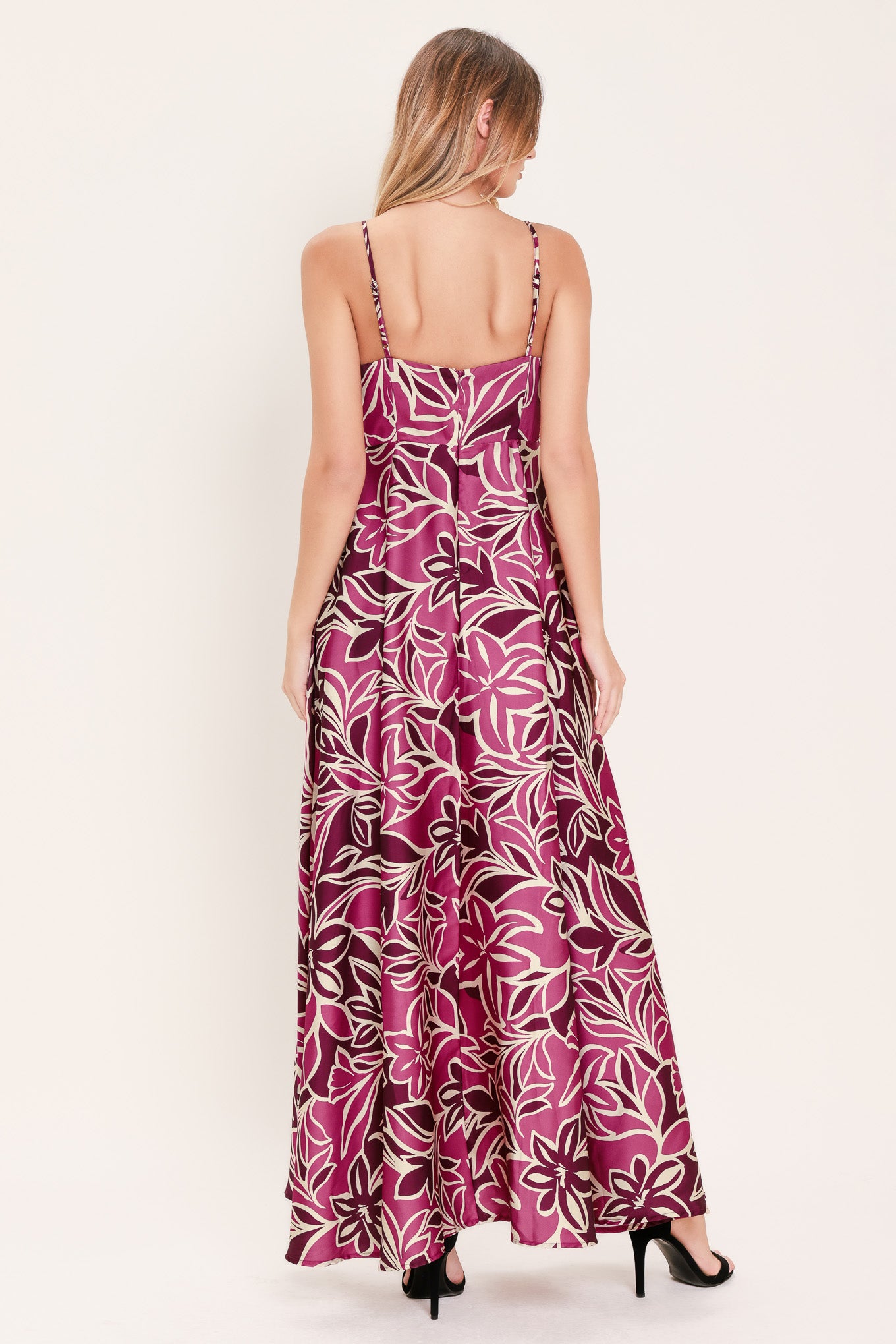 Woman wearing a pink and berry colored tropical floral maxi dress | Flying Tomato