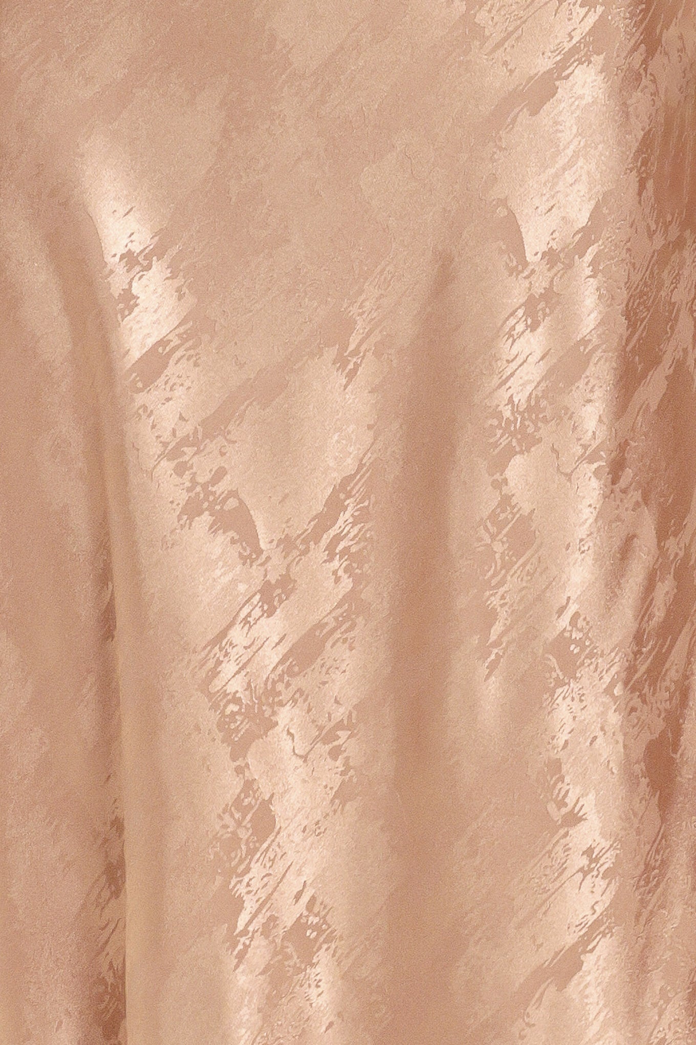 A woman wearing a sleeveless, floor-length metallic champagne-gold gown with a draped neckline and a subtle crinkle texture | Flying Tomato