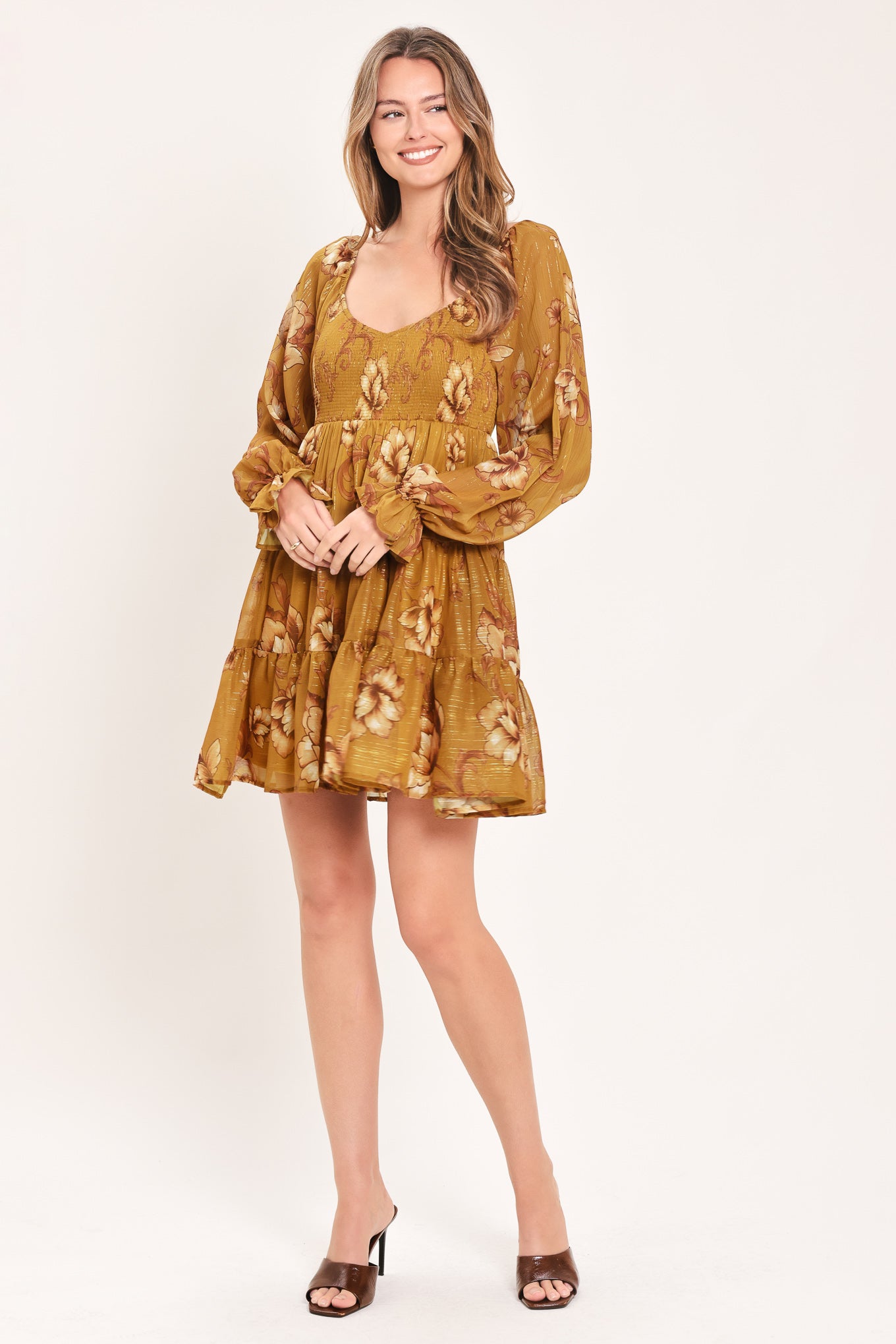 A woman modeling a mustard yellow mini dress with a beige floral pattern, long balloon sleeves, and a V-neckline | FREEMARKET