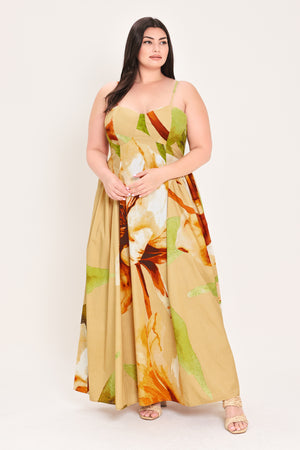 Woman wearing a green with brown and khaki floral printed maxi dress featuring bustier top, straps, side shirring detail and back zipper closure | Flying Tomato