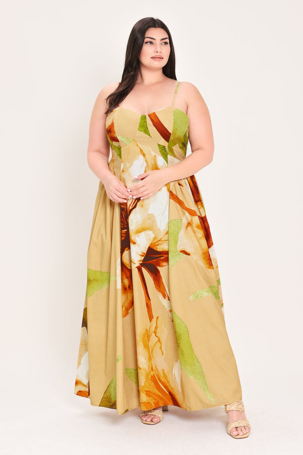 Woman wearing a green with brown and khaki floral printed maxi dress featuring bustier top, straps, side shirring detail and back zipper closure | Flying Tomato