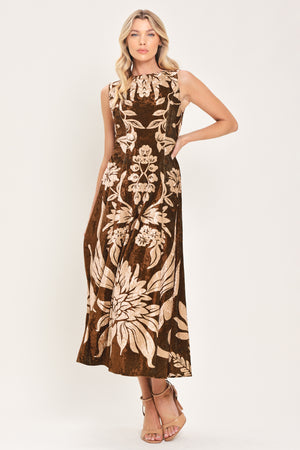 A woman modeling a sleeveless brown velvet midi dress with a large beige floral pattern | Flying Tomato