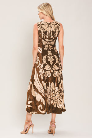 A woman modeling a sleeveless brown velvet midi dress with a large beige floral pattern | Flying Tomato