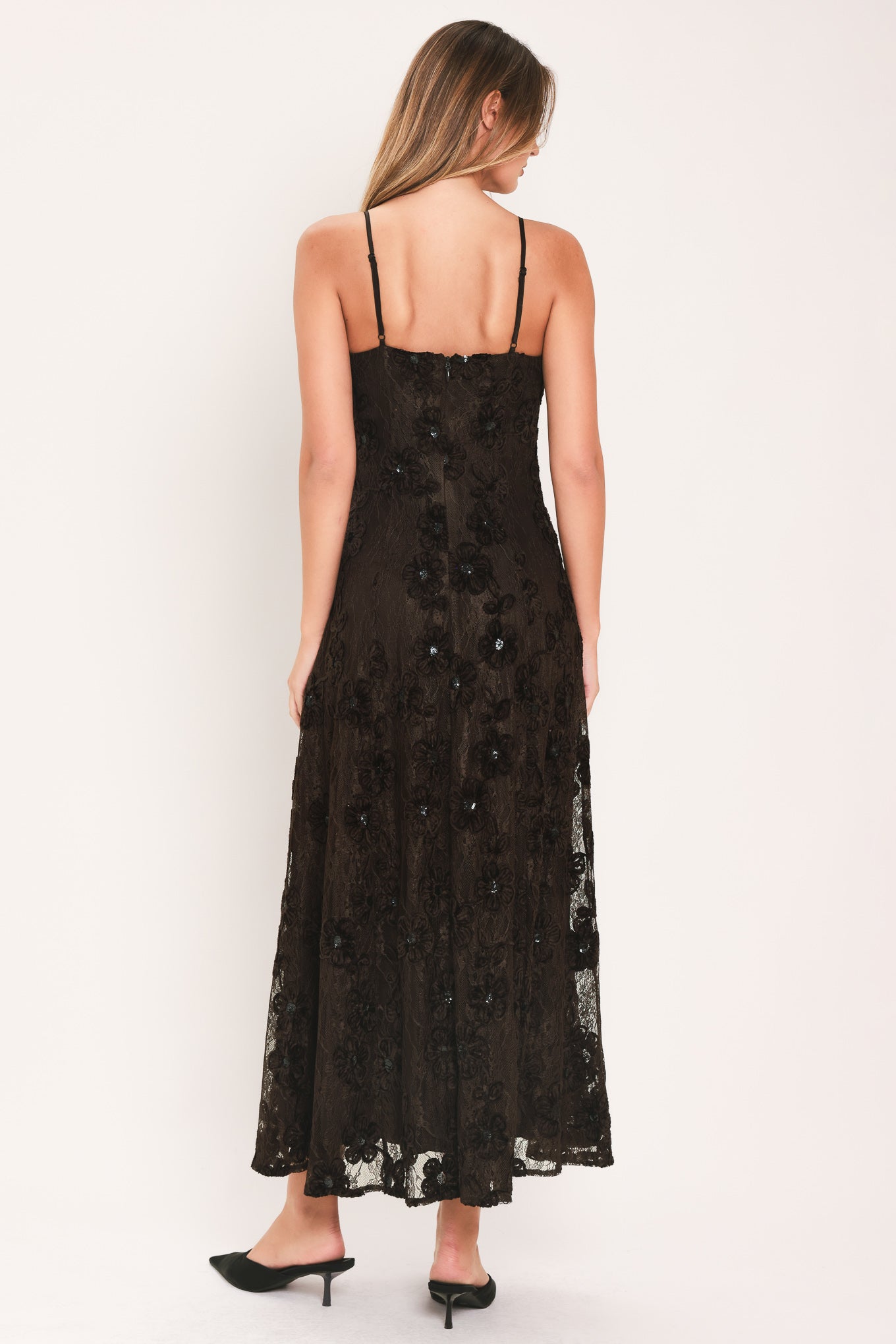 A woman modeling a brown lace midi dress with thin spaghetti straps, a fitted bodice, and a flared skirt | Flying Tomato