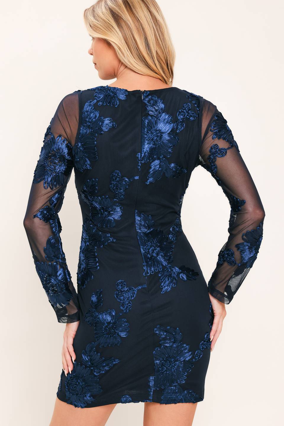 Woman wearing a navy and black solid embellished power mesh mini dress with round neckline, long sleeve and back zipper closure | Flying Tomato