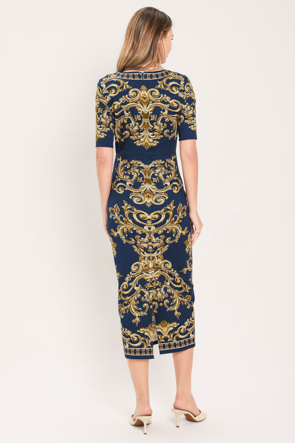 A woman wearing a navy blue midi dress with an ornate gold baroque pattern, featuring short sleeves and a crew neck | Flying Tomato