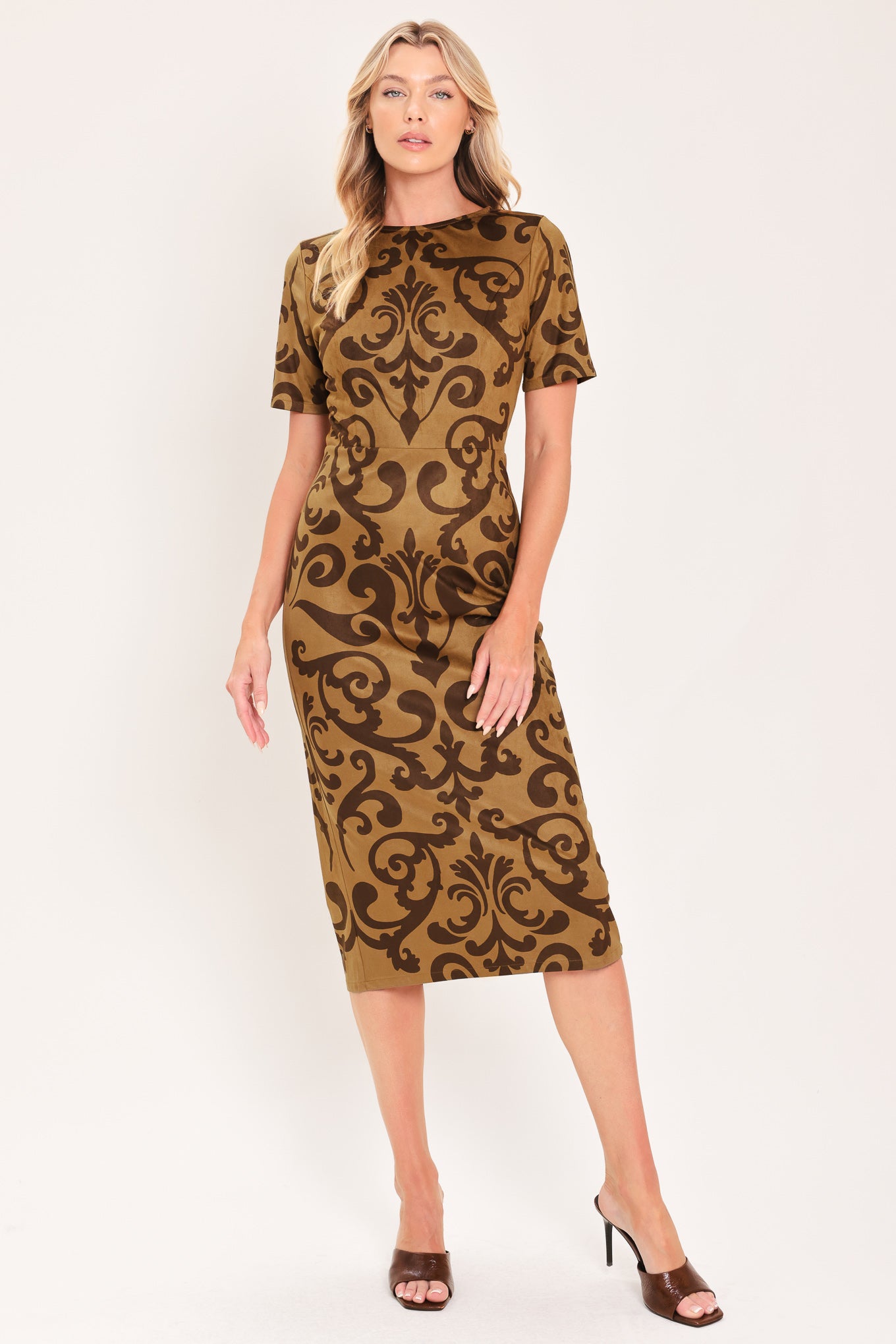 A woman modeling a short-sleeve faux suede camel midi dress with a brown damask pattern | Flying Tomato