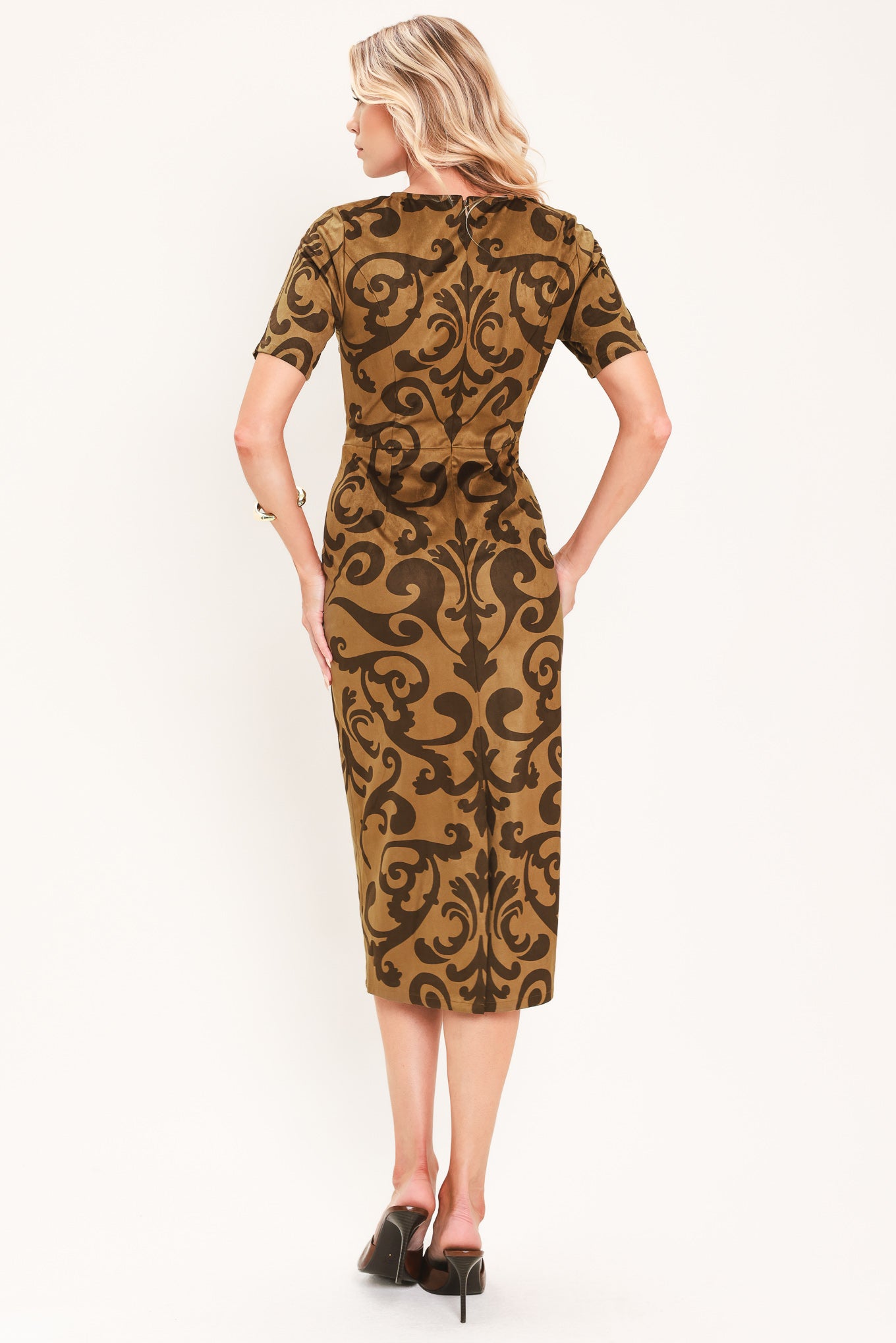 A woman modeling a short-sleeve faux suede camel midi dress with a brown damask pattern | Flying Tomato