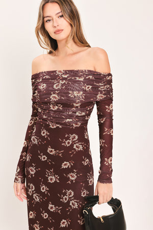 A woman modeling an off-the-shoulder long-sleeve maxi dress with a dark brown base and a beige floral pattern | Flying Tomato